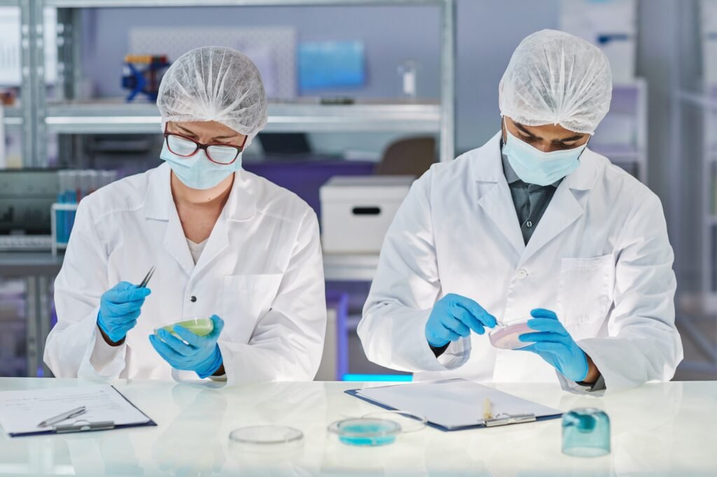Chemists mixing chemicals in test tubes